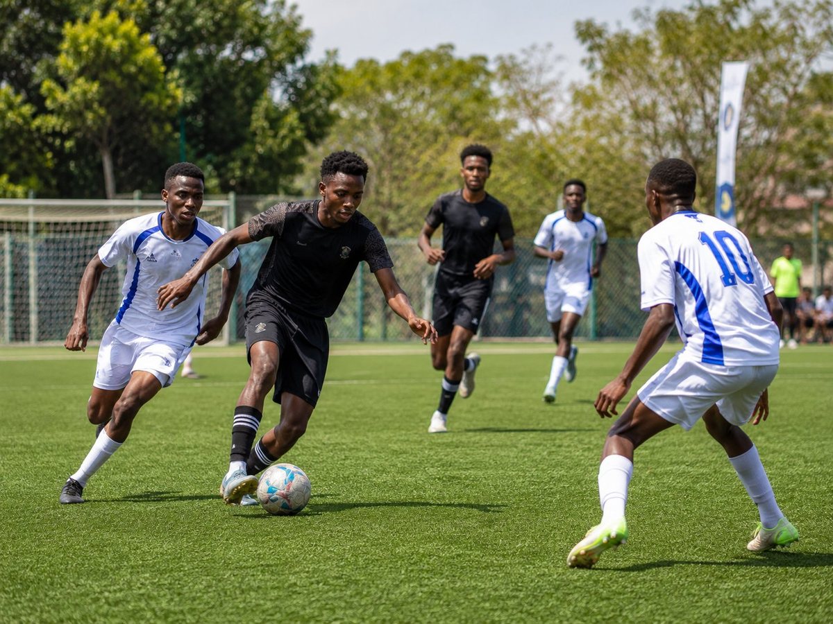 University students playing a game of football on the pitch